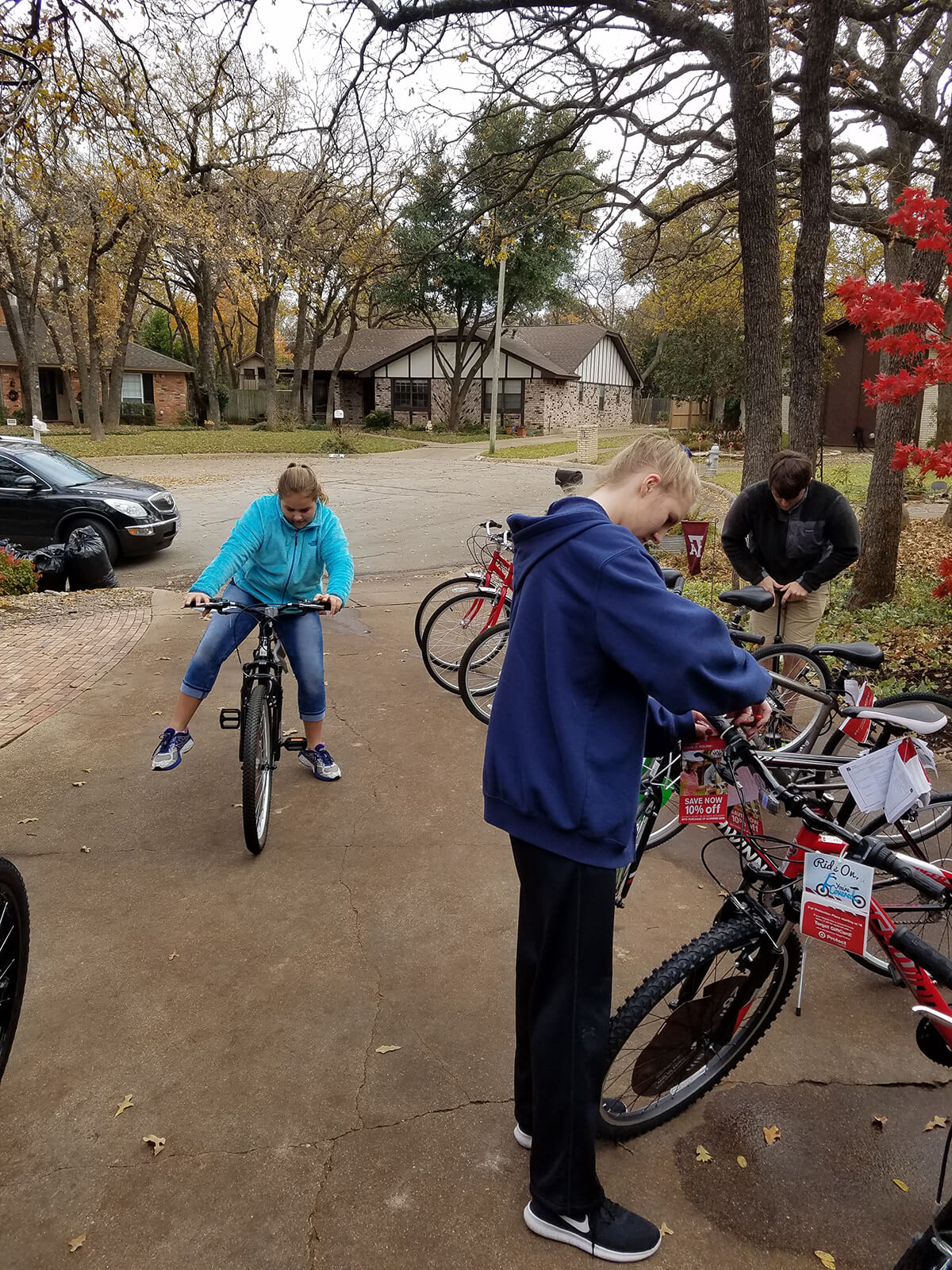 Trey, Audrey and Abby prepping and testing the bikes before delivery
